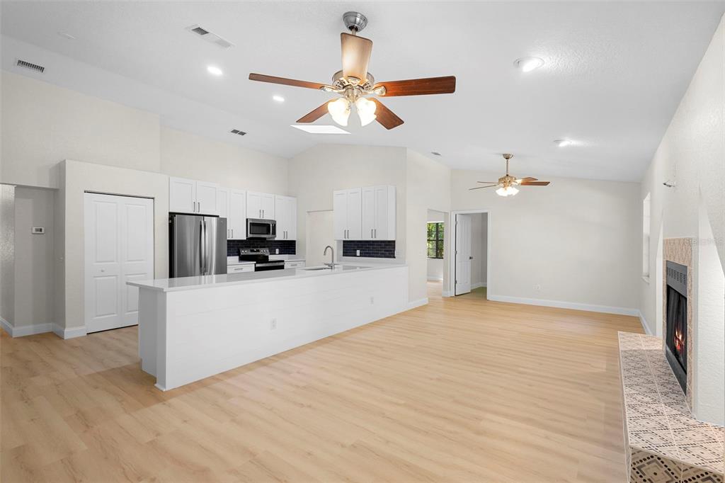 26 Laurianne Road DeBary, FL 32713 - Photo 34 of 41 a view of kitchen with stainless steel appliances refrigerator stove microwave and cabinets