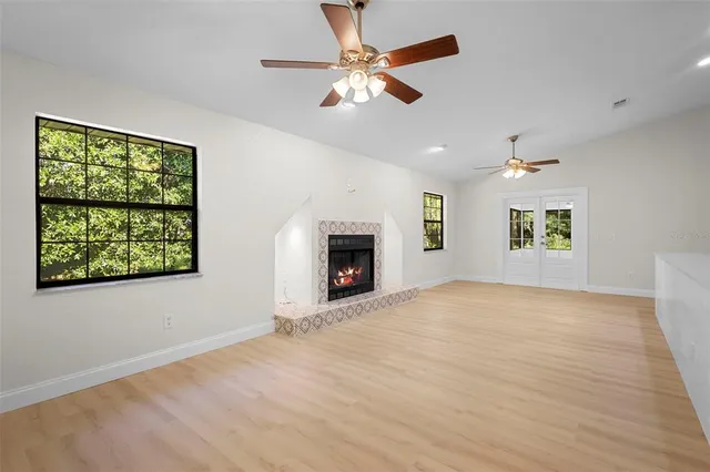 an empty room with fan and windows