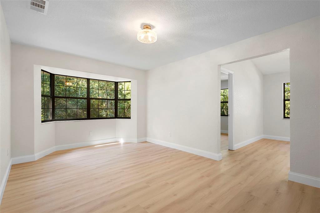 26 Laurianne Road DeBary, FL 32713 - Photo 10 of 41 wooden floor in an empty room with a window