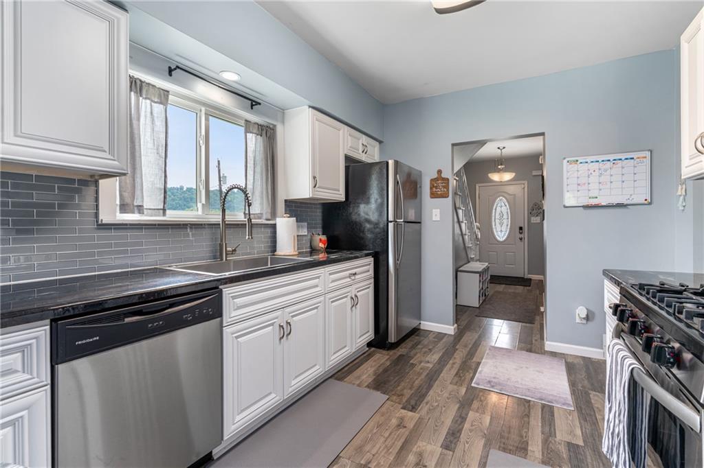 334 Orchard Street Springdale, PA 15144 - Photo 11 of 25 a kitchen with stainless steel appliances a stove sink and refrigerator