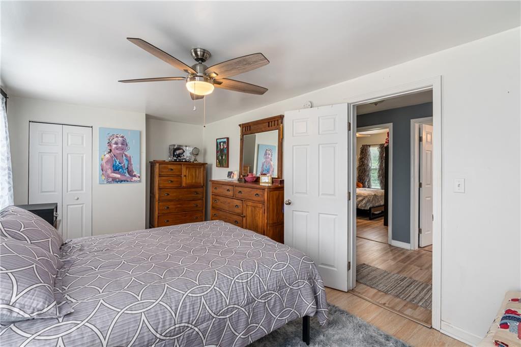 334 Orchard Street Springdale, PA 15144 - Photo 15 of 25 a bedroom with a bed and a chandelier