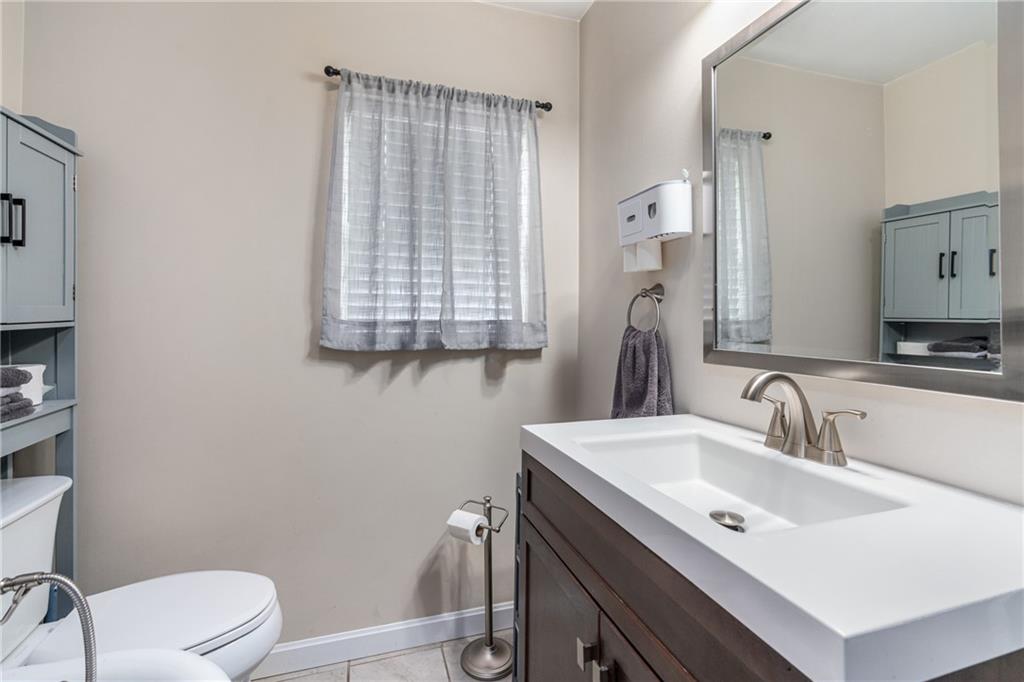 334 Orchard Street Springdale, PA 15144 - Photo 16 of 25 a bathroom with a toilet sink and mirror