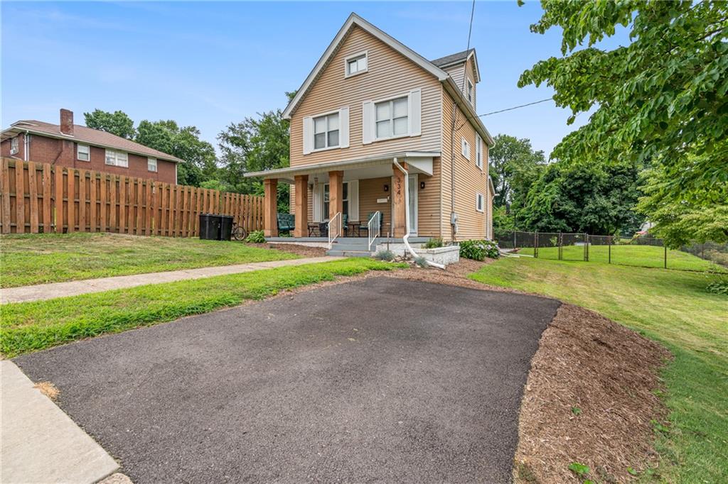 334 Orchard Street Springdale, PA 15144 - Photo 2 of 25 a front view of a house with a yard and trees