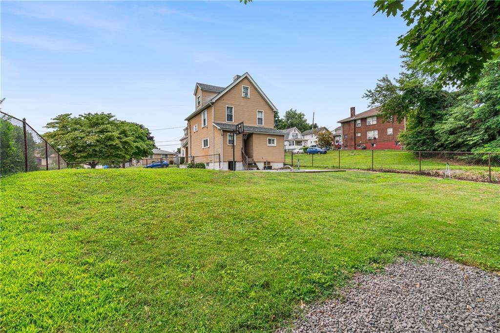 334 Orchard Street Springdale, PA 15144 - Photo 24 of 25 a house with garden in front of it