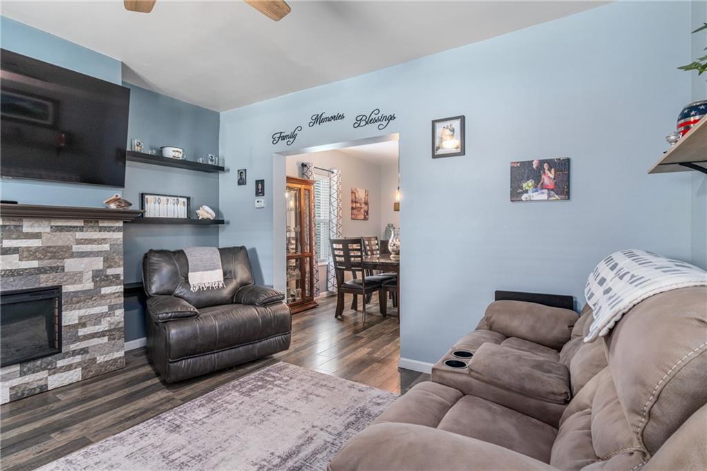 334 Orchard Street Springdale, PA 15144 - Photo 5 of 25 a living room with furniture a flat screen tv and a fireplace