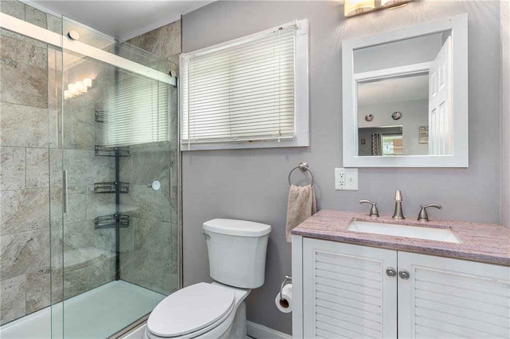 334 Orchard Street Springdale, PA 15144 - Photo 9 of 25 a bathroom with a sink a toilet and shower