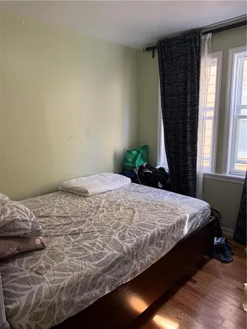 a bed sitting in a bedroom next to a window