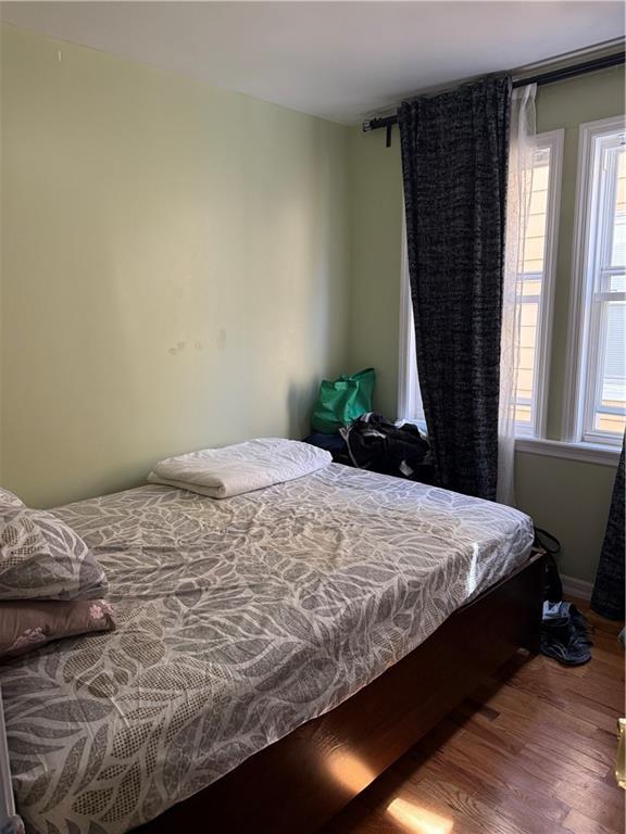 3016 Brighton 3rd Street Brooklyn, NY 11235 - Photo 14 of 21 a bed sitting in a bedroom next to a window