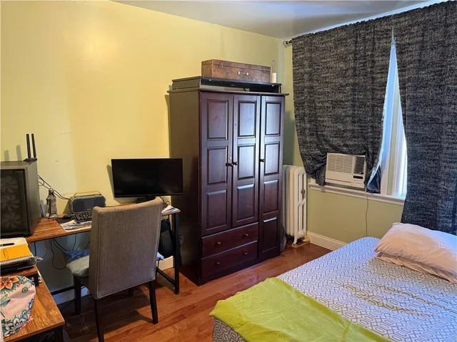 a bedroom with a bed and a television