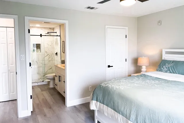 a bedroom with a bed and a view of bathroom