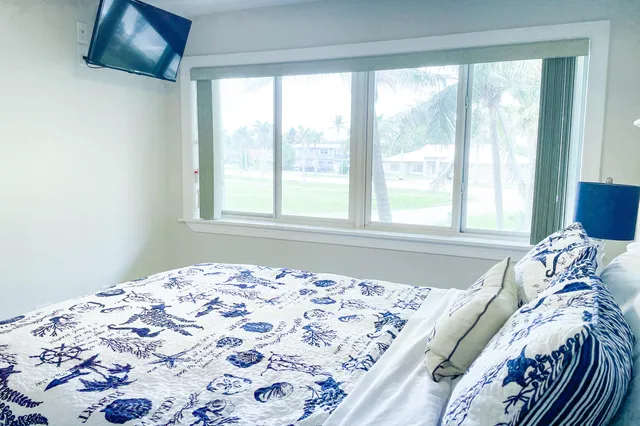 a bed sitting in a bedroom next to a window