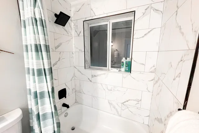 a bathroom with a bathtub and shower