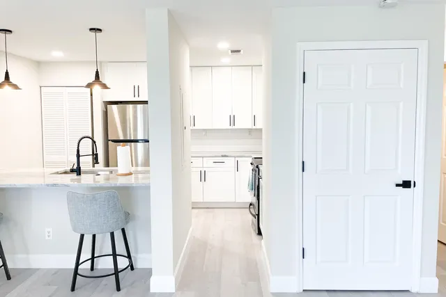 a view of a kitchen with a sink and wooden floor
