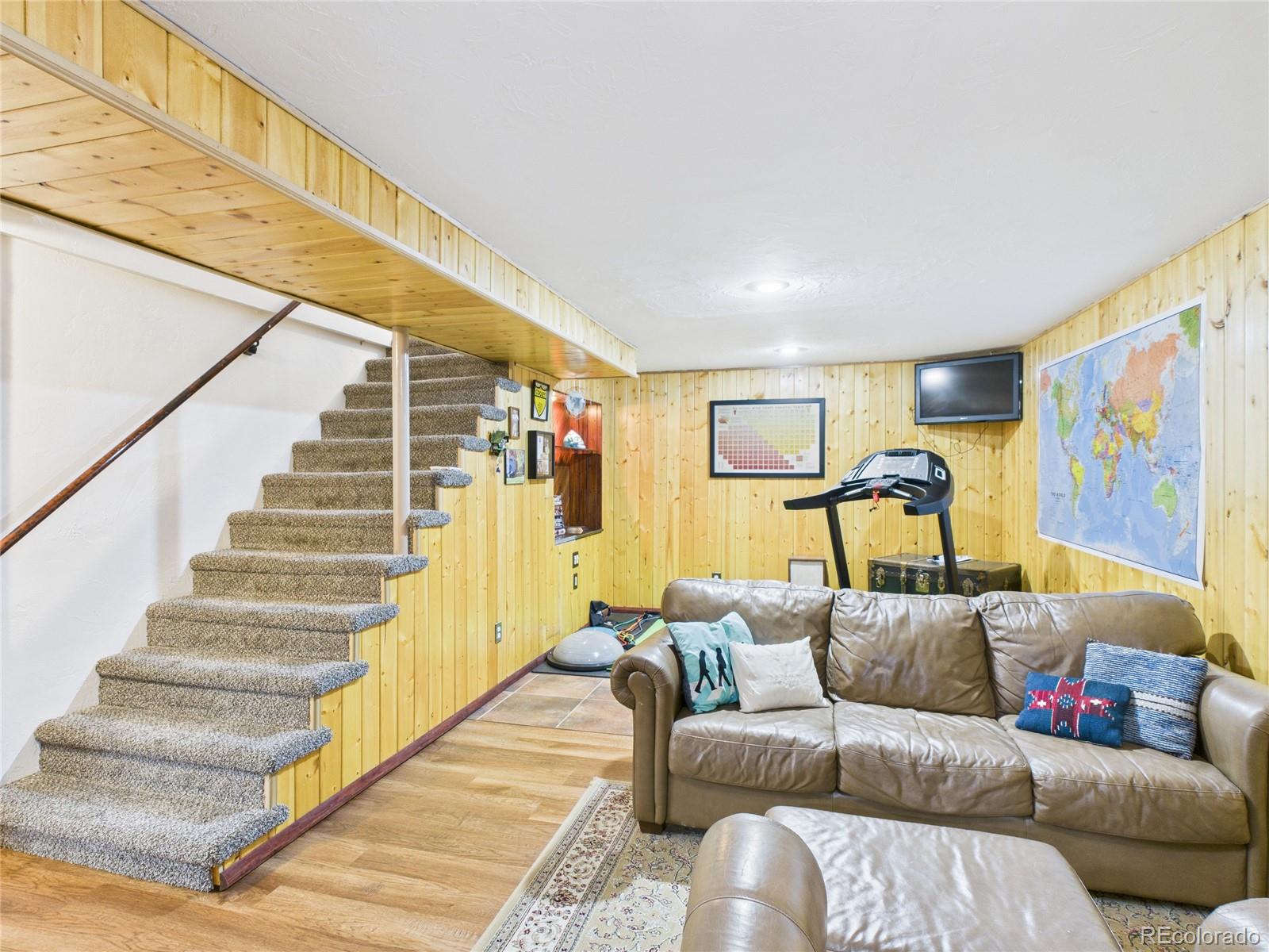 1360 South Ivy Way Denver, CO 80224 - Photo 12 of 23 a living room with furniture and stairs