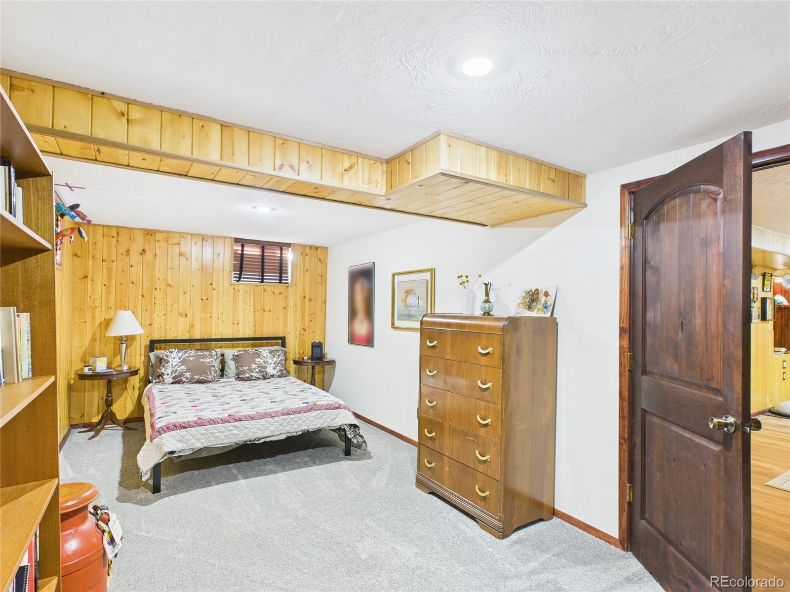 1360 South Ivy Way Denver, CO 80224 - Photo 15 of 23 a bedroom with a bed and wooden floor
