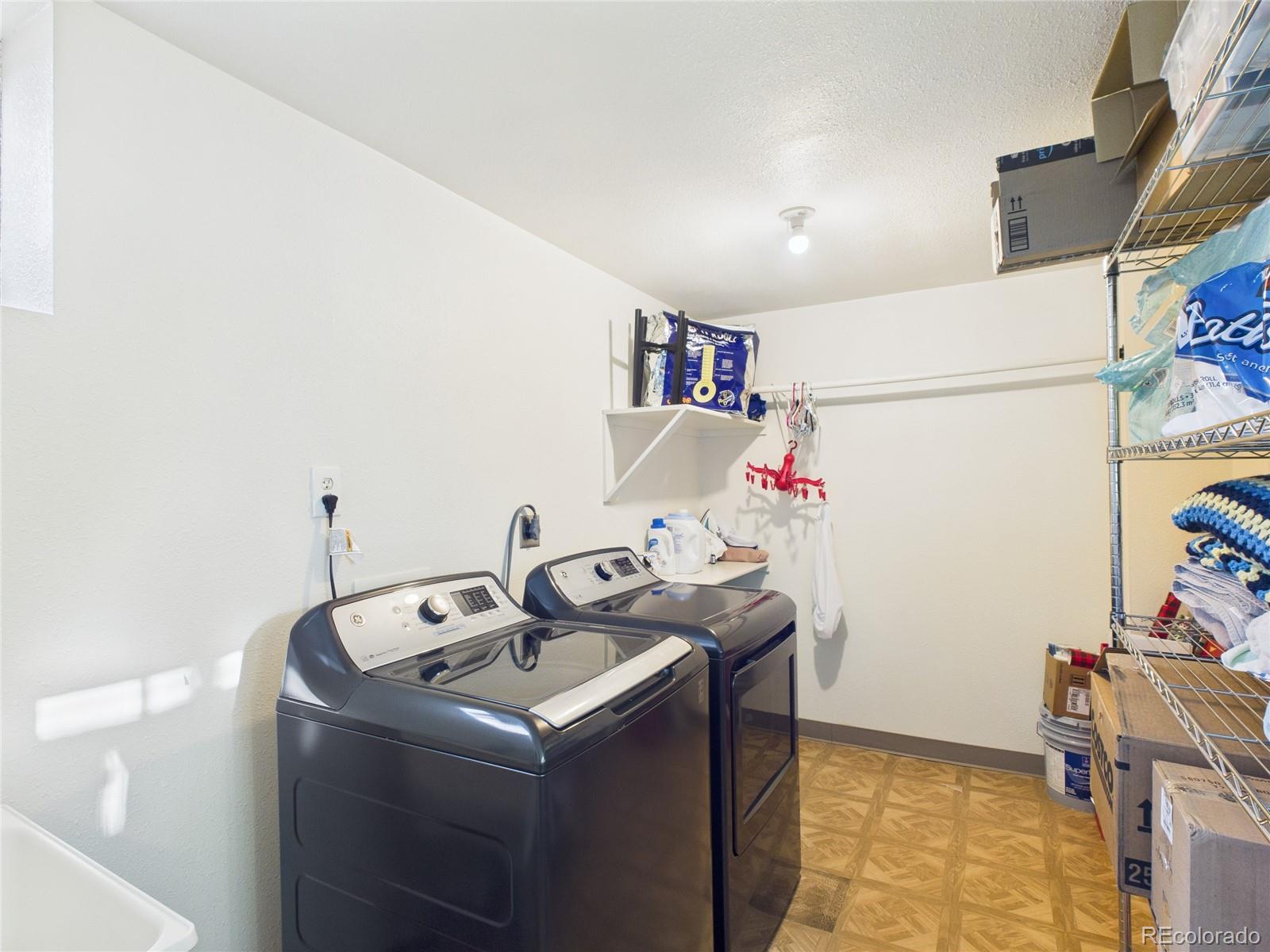 1360 South Ivy Way Denver, CO 80224 - Photo 16 of 23 a utility room with dryer and washer