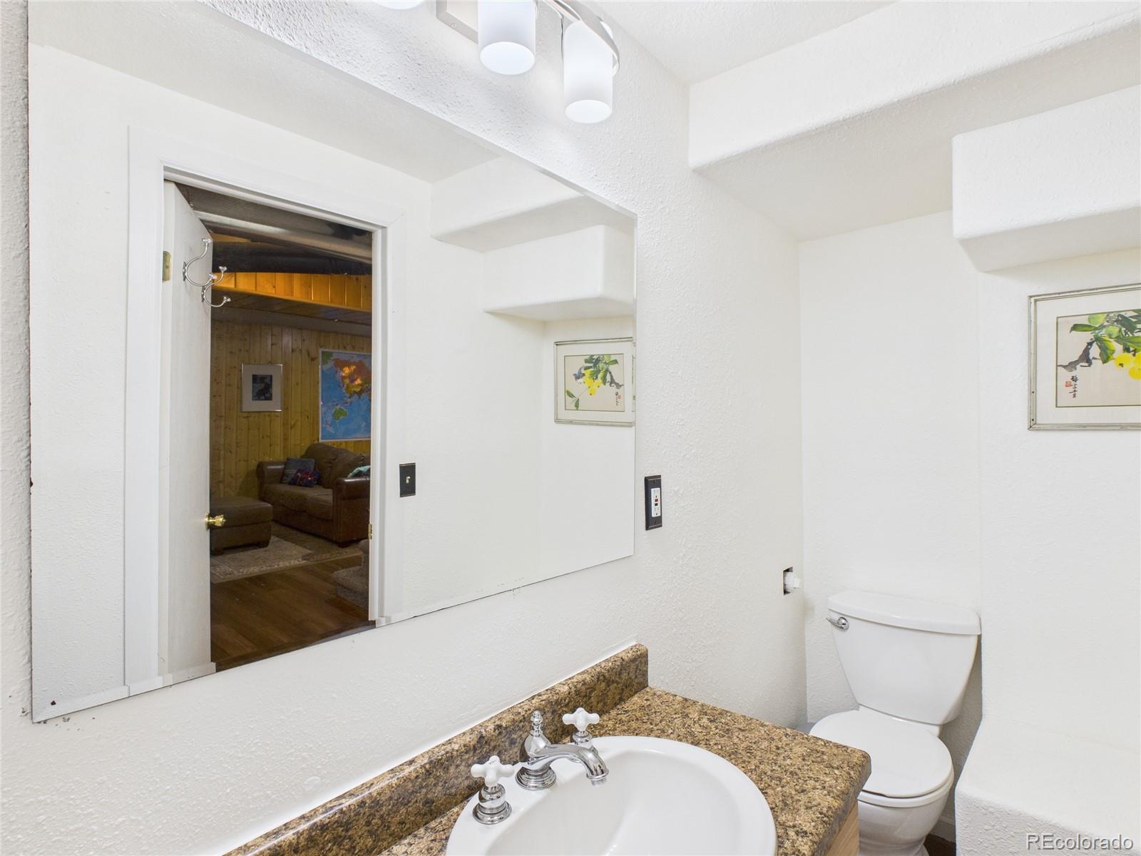 1360 South Ivy Way Denver, CO 80224 - Photo 17 of 23 a bathroom with a sink and a mirror