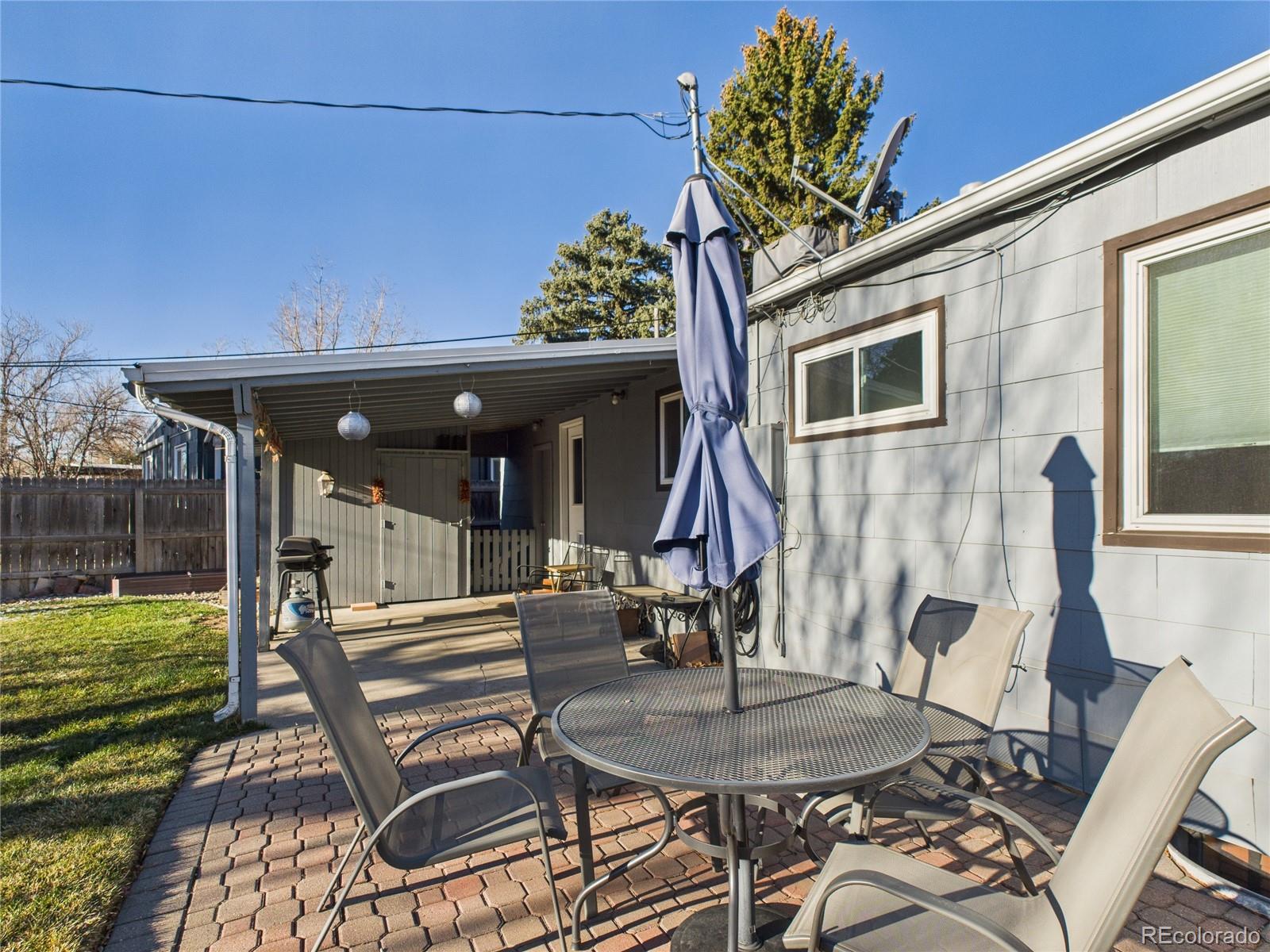 1360 South Ivy Way Denver, CO 80224 - Photo 23 of 23 a view of a patio with table and chairs and potted plants