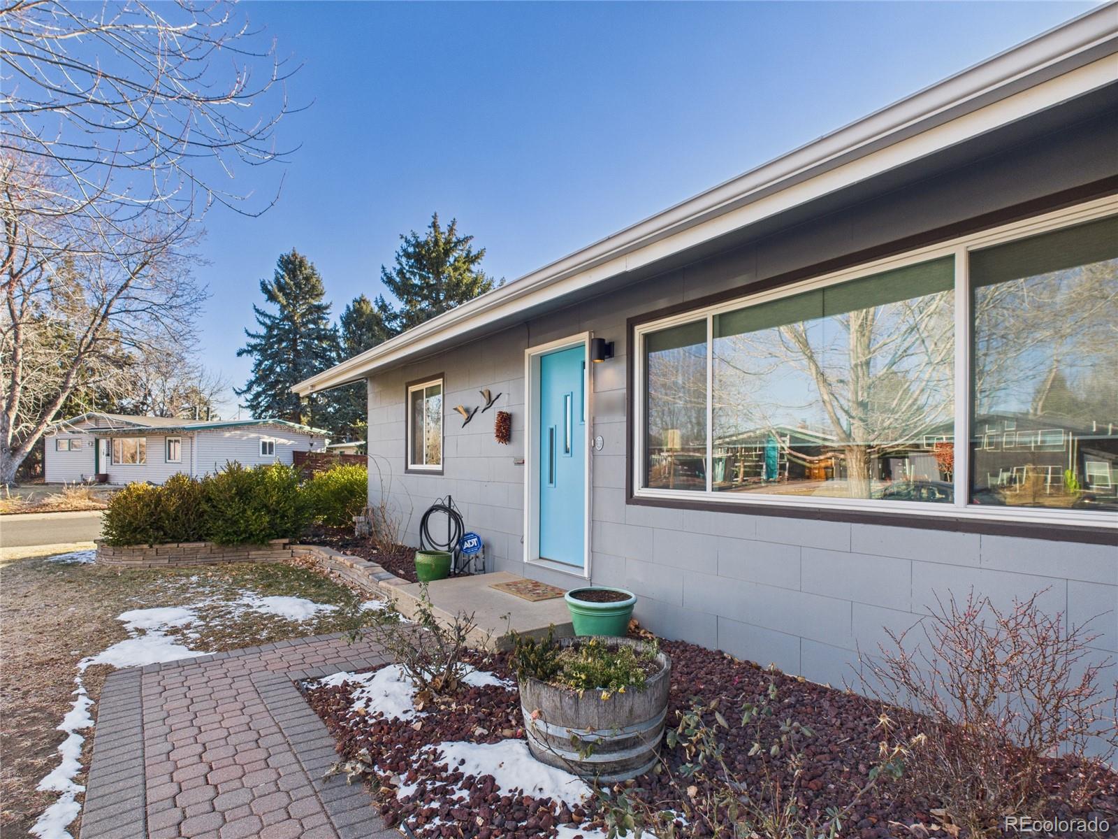 1360 South Ivy Way Denver, CO 80224 - Photo 3 of 23 a front view of a house with garden