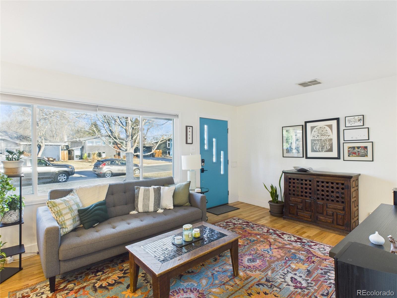 1360 South Ivy Way Denver, CO 80224 - Photo 5 of 23 a living room with furniture and a rug
