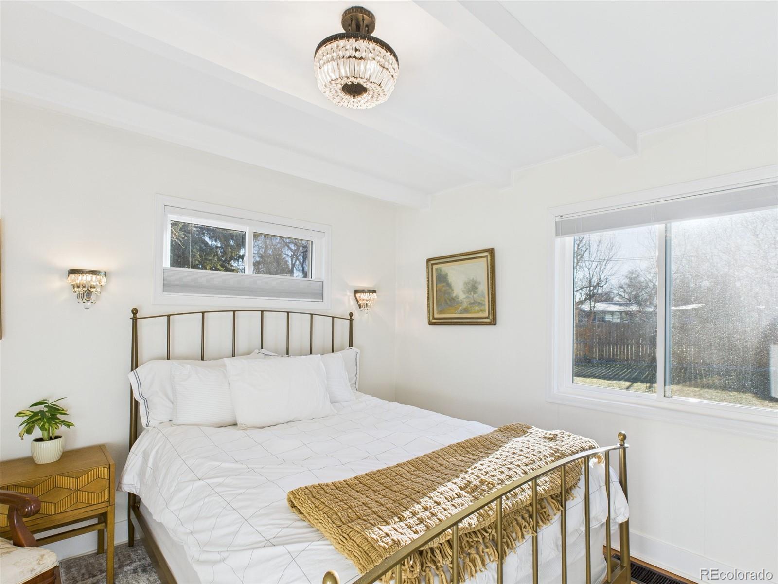 1360 South Ivy Way Denver, CO 80224 - Photo 10 of 23 a bedroom with a bed and a window