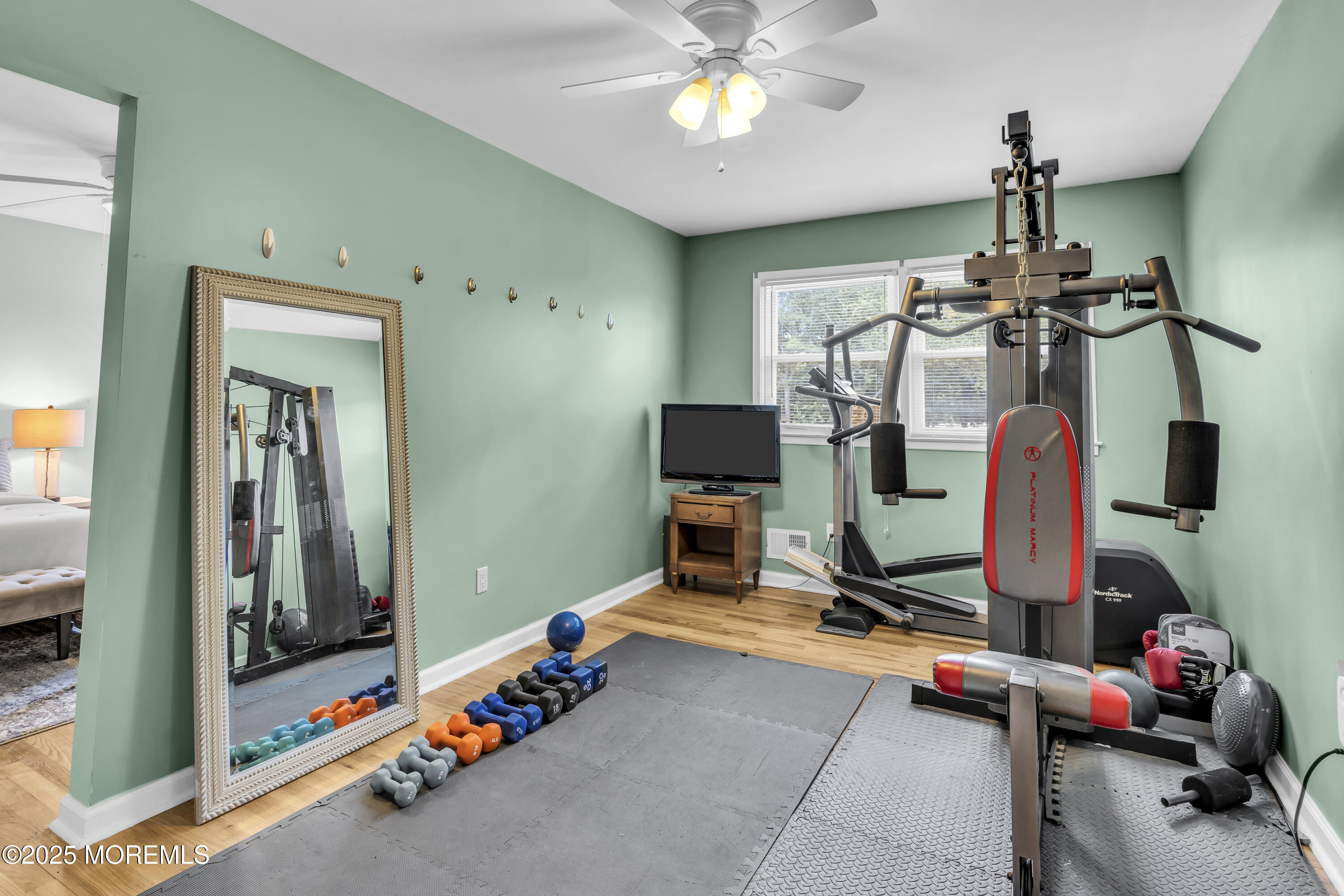 40 South Westfield Road Howell, NJ 07731 - Photo 24 of 36 a room with gym equipment and a mirror