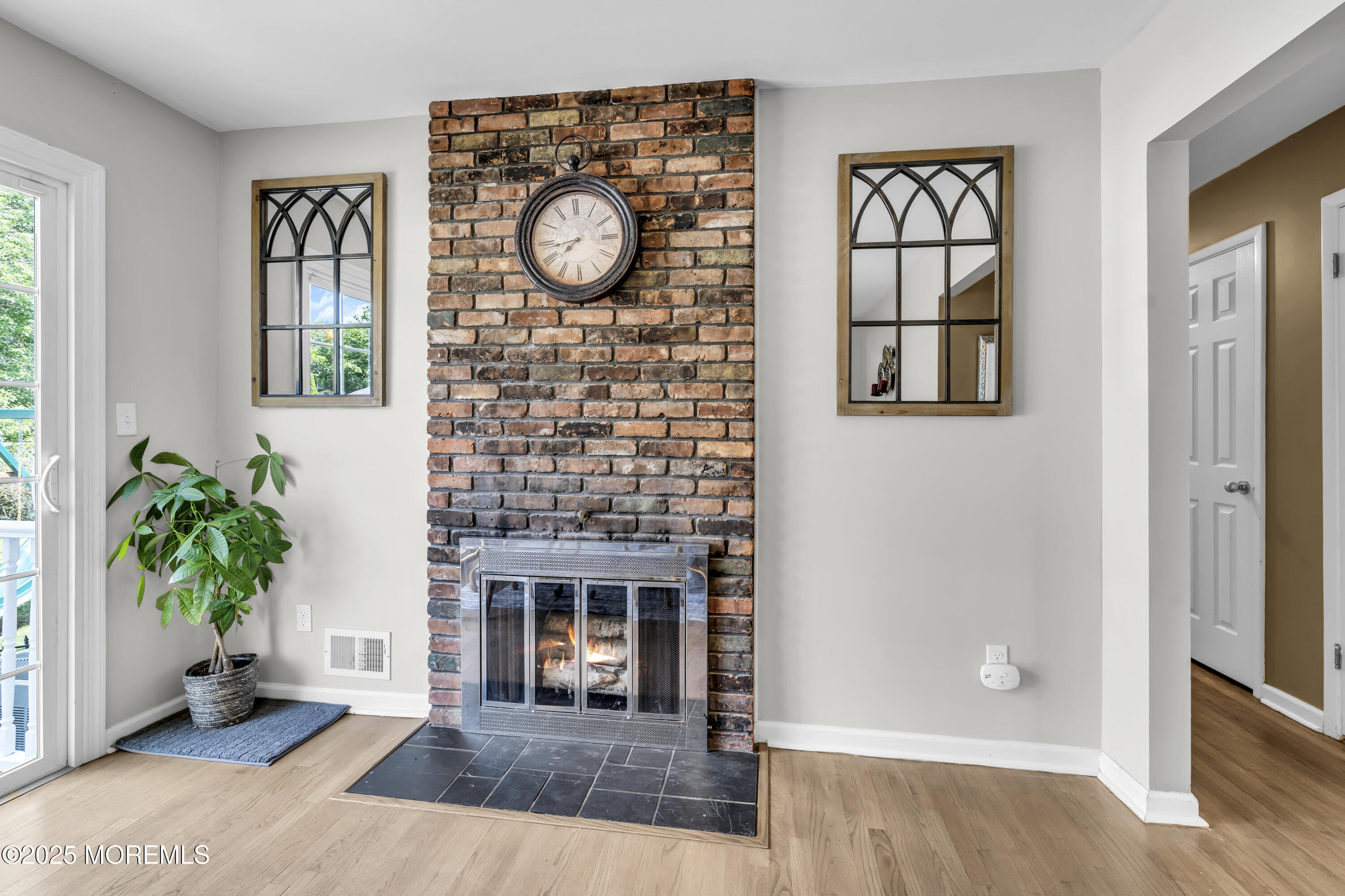 40 South Westfield Road Howell, NJ 07731 - Photo 10 of 36 a view of a livingroom with wooden floor and a fireplace