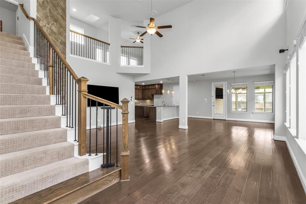 6333 Hall Road Frisco, TX 75034 - Photo 7 of 38 Grand entryway featuring a carpeted staircase with wood handrails and wrought iron balusters