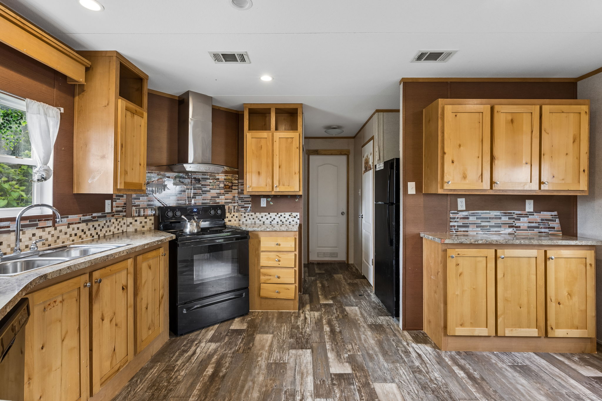 253 North County Line Road, Unit C Elgin, TX 78621 - Photo 11 of 39 A well-equipped culinary space boasts a double basin sink and ample cabinetry for storage.