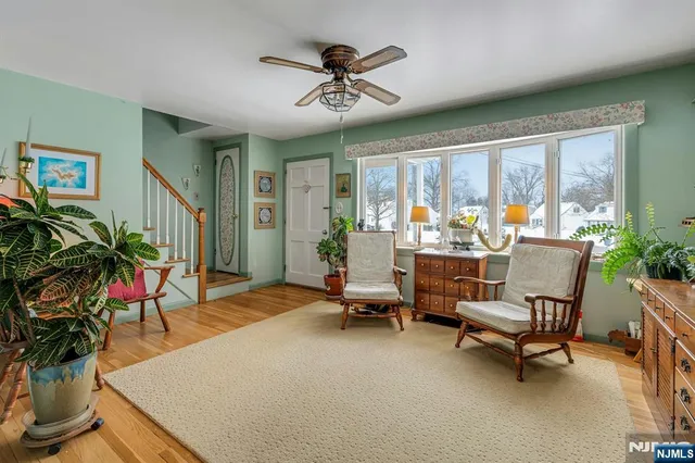 a living room with patio furniture and a large window