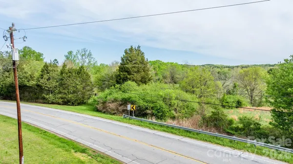 a view of a yard with potted plants
