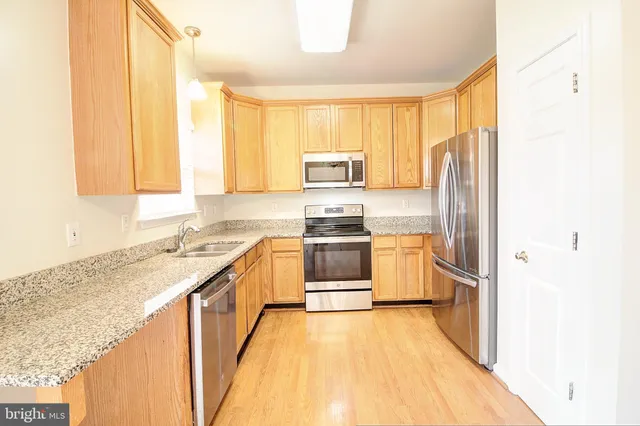 a kitchen with a sink a stove and a refrigerator