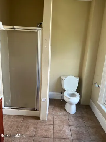 a white toilet sitting next to a bathroom sink
