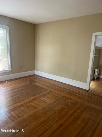 a view of room with wooden floor