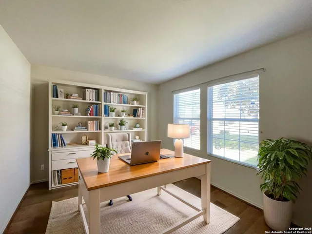 a workspace with furniture and a potted plant