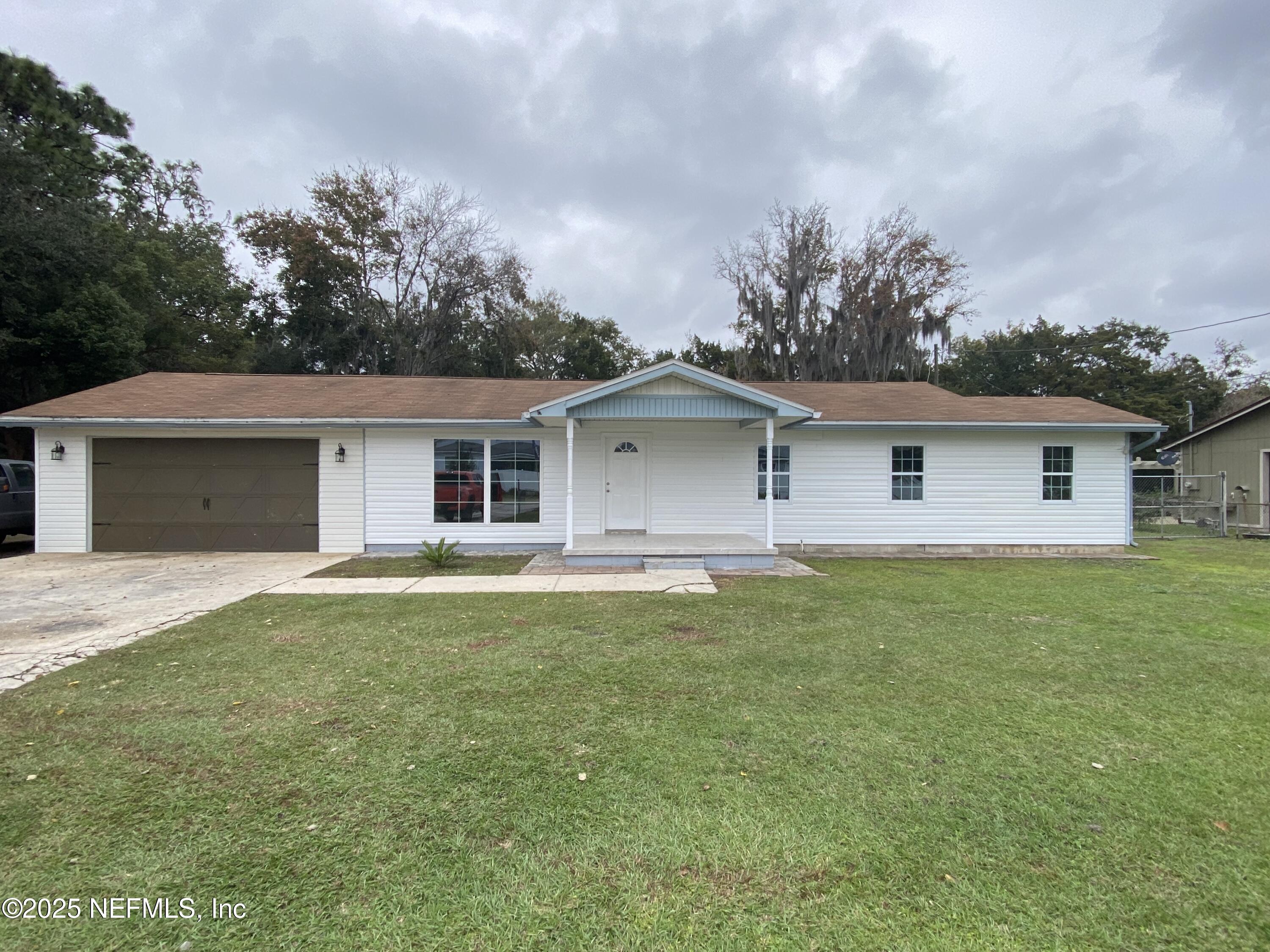 a front view of house with yard and green space