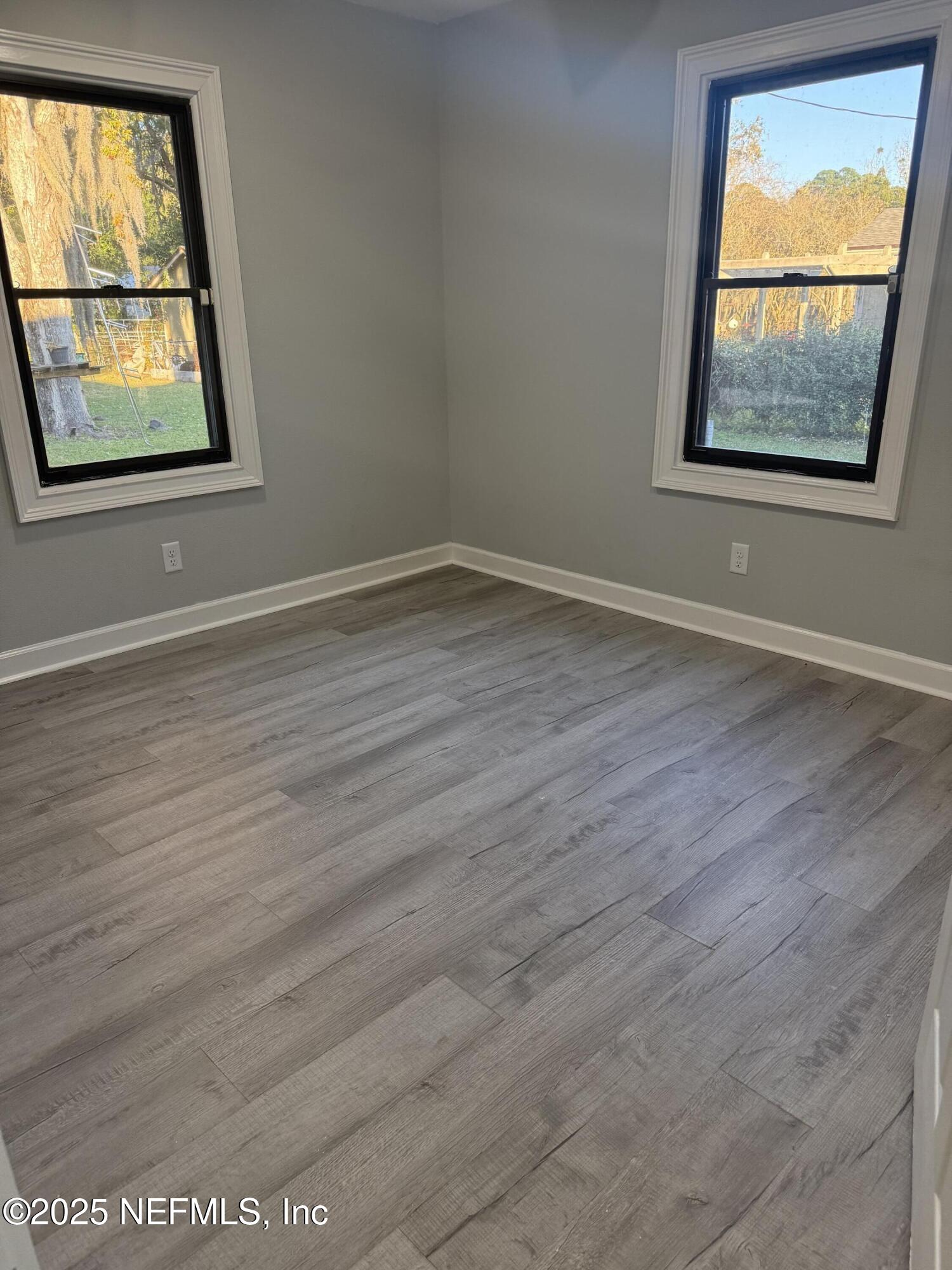 4901 Cedar Point Road Jacksonville, FL 32226 - Photo 11 of 15 an empty room with wooden floor and windows