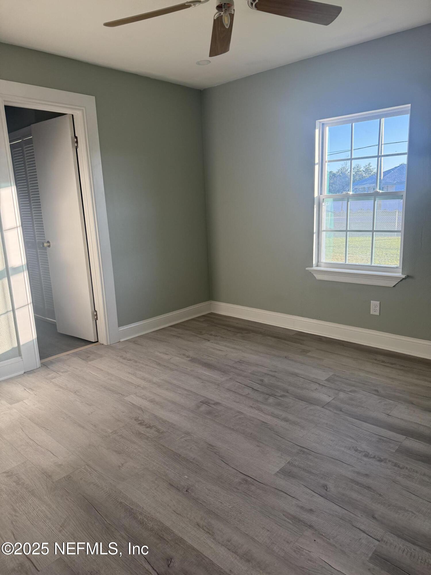 4901 Cedar Point Road Jacksonville, FL 32226 - Photo 13 of 15 an empty room with wooden floor and windows