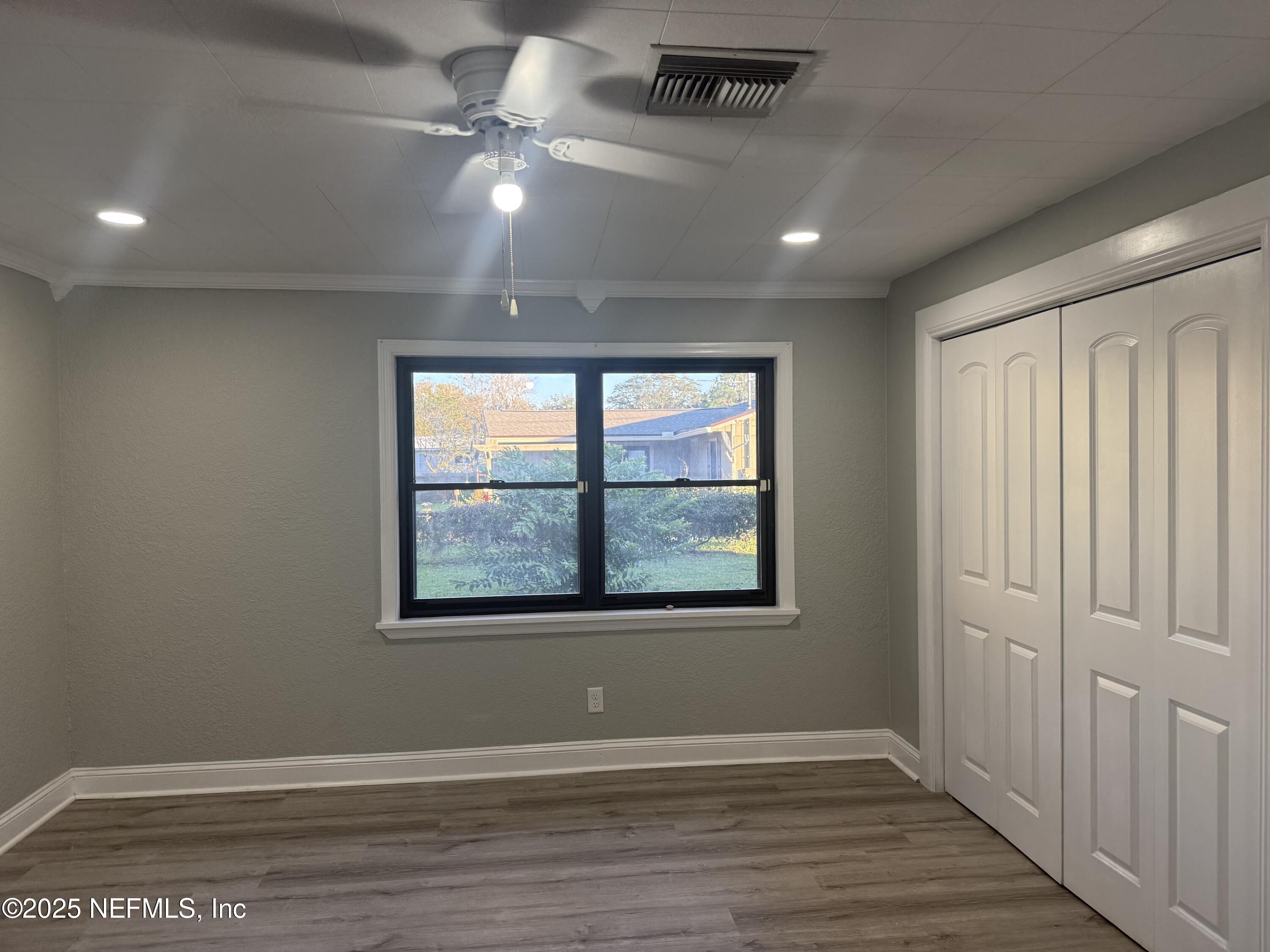 4901 Cedar Point Road Jacksonville, FL 32226 - Photo 15 of 15 an empty room with wooden floor and windows