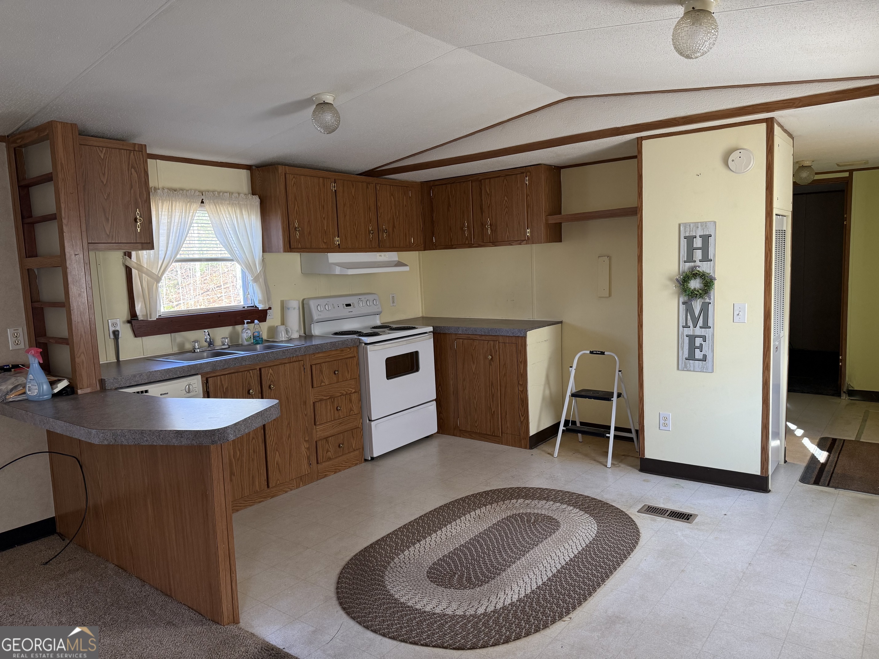 354 Ridgeview Circle Morganton, GA 30560 - Photo 5 of 10 a room with stainless steel appliances granite countertop a sink a stove and a refrigerator
