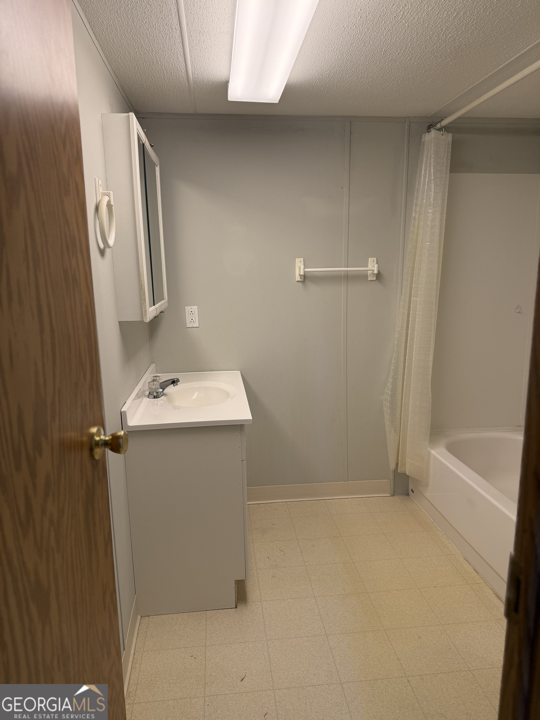 354 Ridgeview Circle Morganton, GA 30560 - Photo 6 of 10 a bathroom with a sink a mirror and shower