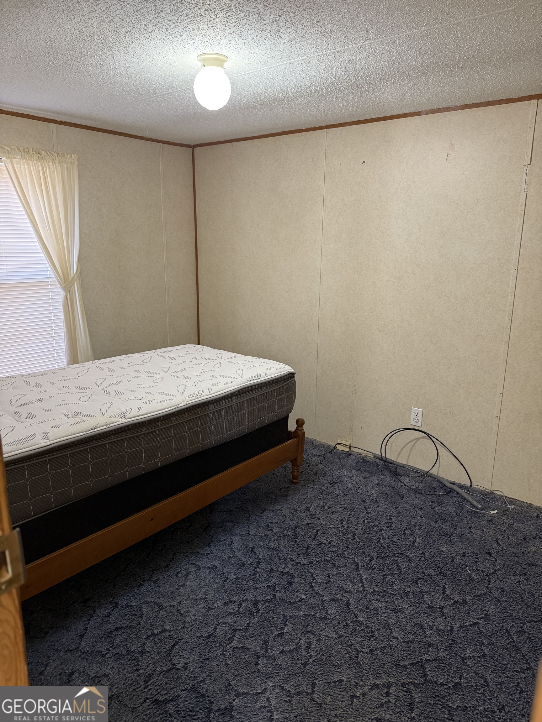 354 Ridgeview Circle Morganton, GA 30560 - Photo 8 of 10 a bedroom with a bed and wooden floor