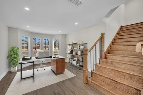 a livingroom with furniture wooden floor and windows