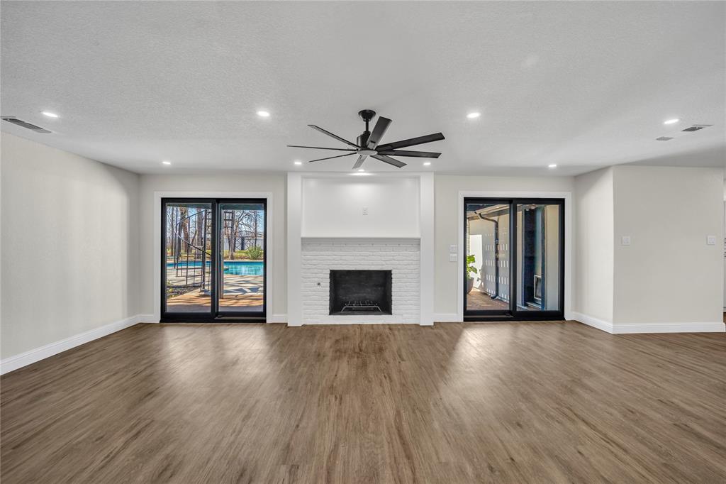 7004 Ledbetter Road Arlington, TX 76001 - Photo 20 of 39 a view of an empty room with wooden floor and a window