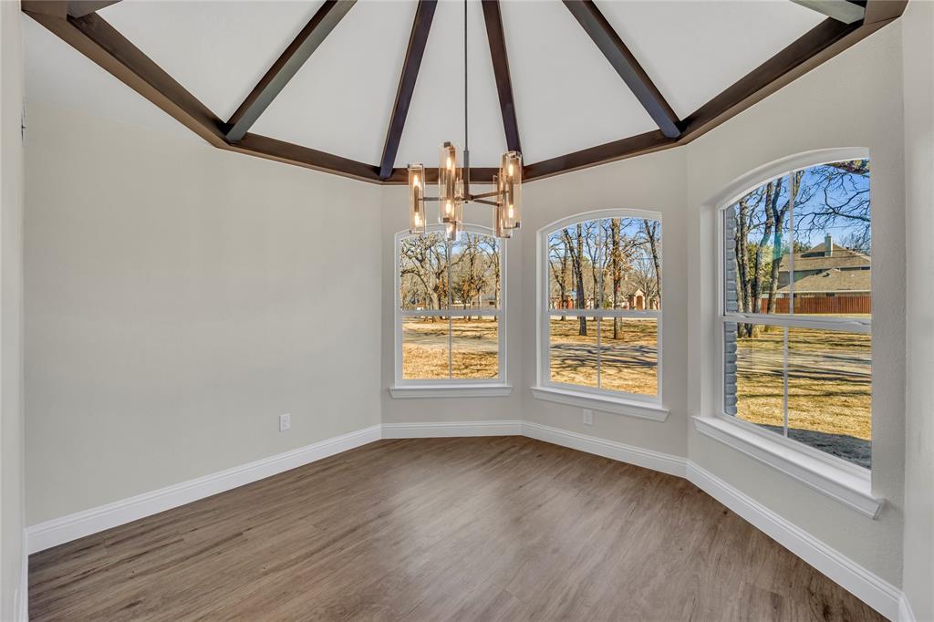 7004 Ledbetter Road Arlington, TX 76001 - Photo 24 of 39 a view of an empty room with a window and wooden floor