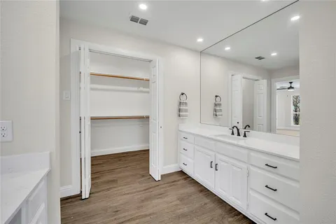 a bathroom with a double vanity sink and mirror