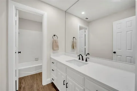 a bathroom with a sink a shower and a mirror