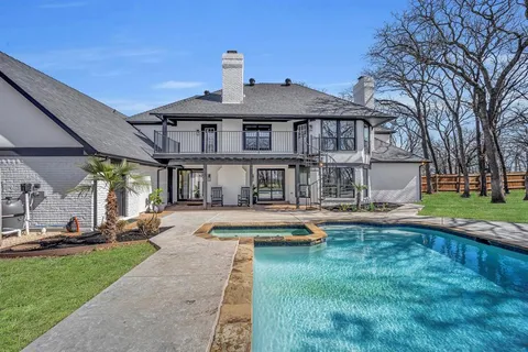 a front view of a house with swimming pool having outdoor seating