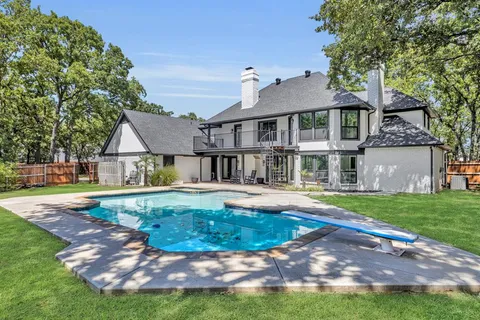 a view of a house with swimming pool and a yard