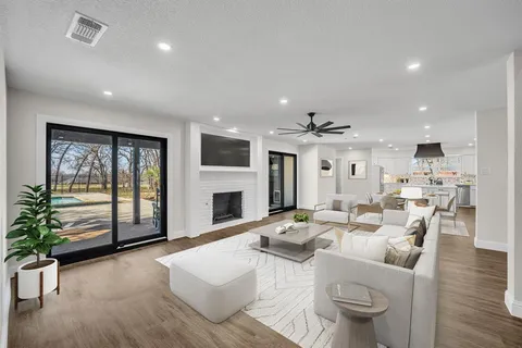 a living room with furniture a fireplace and a potted plant